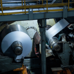 Cold rolling mill in operation, processing steel sheets to enhance quality and durability.